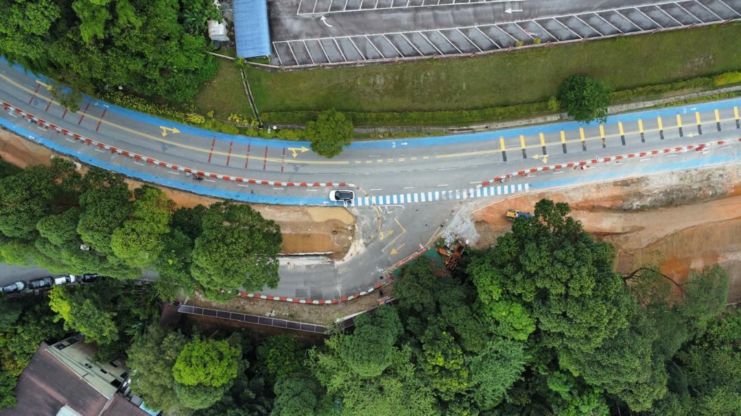 Jabatan Perhutanan access road — completed carriageway, wide shot